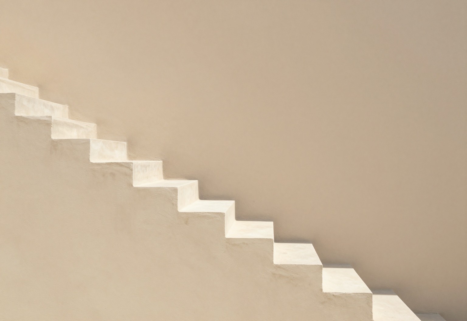 Sunlight falling down a minimalist descending staircase