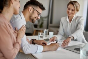 A man signing a loan after deciding between FHA vs. VA loans